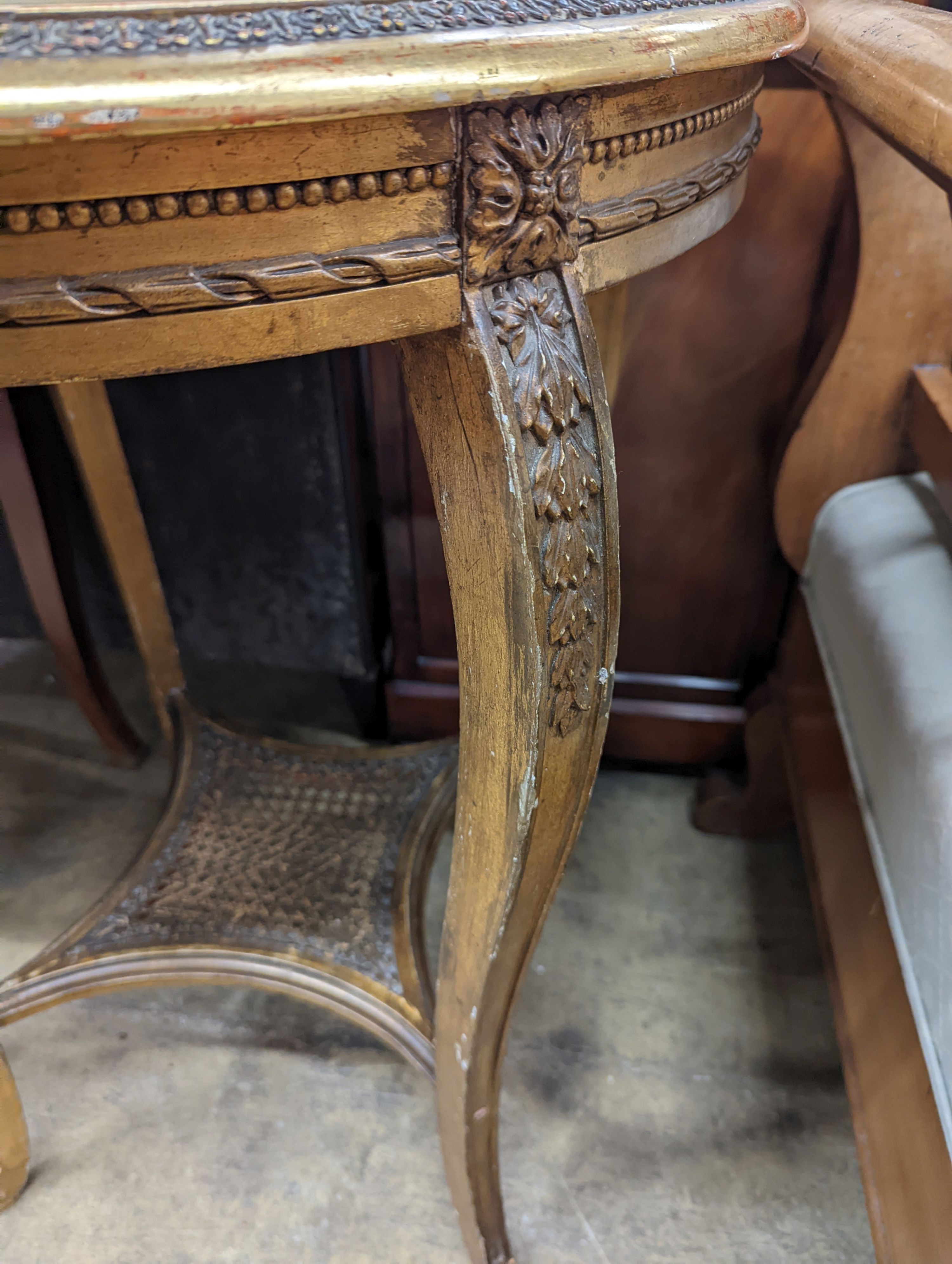 A French caned giltwood circular centre table with reconstituted marble top, diameter 55cm, height 76cm